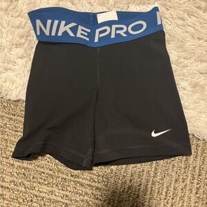 Extra small black Nike pro shirts with blue waistband